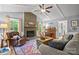 Cozy living room featuring a brick fireplace, vaulted ceilings, and natural light at 9707 Enid Ln, Matthews, NC 28105