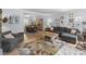 Spacious living room with hardwood floors, open to the dining area, and flooded with natural light at 9707 Enid Ln, Matthews, NC 28105