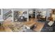 Open-concept living room with hardwood floors and seamless flow to kitchen and dining areas at 9707 Enid Ln, Matthews, NC 28105