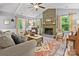 Warm and inviting living room with a brick fireplace, hardwood floors, and comfortable seating at 9707 Enid Ln, Matthews, NC 28105