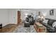 Inviting living area with dark leather furniture, area rugs, and views to additional spaces at 9707 Enid Ln, Matthews, NC 28105