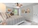 Comfortable bedroom featuring a striped bedspread and natural light from the surrounding windows at 9707 Enid Ln, Matthews, NC 28105