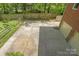 Spacious backyard patio and lawn with a wood fence and partial view of the house at 9707 Enid Ln, Matthews, NC 28105