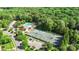 Aerial view of community tennis courts and a pool area with slides, surrounded by lush trees, creating a vibrant recreational hub at 1004 Berwick Ct, Waxhaw, NC 28173