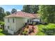 Landscaped backyard with patio, hot tub, and lush greenery, creating a peaceful oasis at 1004 Berwick Ct, Waxhaw, NC 28173