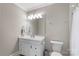 Well-lit bathroom with a white vanity, a classic mirror, and essential fixtures at 1004 Berwick Ct, Waxhaw, NC 28173