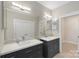 Bright bathroom with double sinks, white countertops, and ample cabinet space at 1004 Berwick Ct, Waxhaw, NC 28173