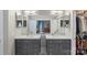 Beautiful bathroom features dual sinks, vanity storage, and a view into the main bedroom at 1004 Berwick Ct, Waxhaw, NC 28173