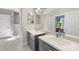 Bright bathroom featuring dual sinks, vanity storage and access to the commode and shower rooms at 1004 Berwick Ct, Waxhaw, NC 28173