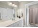 Bright bathroom with a large mirror, vanity, and a view of the shower at 1004 Berwick Ct, Waxhaw, NC 28173