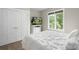 Bright bedroom with closet and backyard views, featuring a television on a bureau at 1004 Berwick Ct, Waxhaw, NC 28173