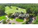 Aerial shot of the clubhouse and golf course, showing manicured grounds and ample parking, perfect for social gatherings at 1004 Berwick Ct, Waxhaw, NC 28173