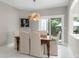 The dining room has a wood table with six chairs, a hanging light fixture, and access to the patio at 1004 Berwick Ct, Waxhaw, NC 28173