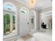 Bright foyer with a white door, marble floors, and modern chandelier at 1004 Berwick Ct, Waxhaw, NC 28173