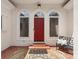 Elegant front entrance featuring red door, arched windows, and stylish rug at 1004 Berwick Ct, Waxhaw, NC 28173