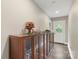 Inviting hallway featuring a custom display cabinet and glass paneled entry door at 1004 Berwick Ct, Waxhaw, NC 28173