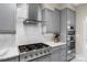 The kitchen has stainless steel gas range, white tile backsplash, and modern vent hood at 1004 Berwick Ct, Waxhaw, NC 28173