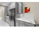 This kitchen has stainless steel refrigerator, marble countertops and gray cabinets at 1004 Berwick Ct, Waxhaw, NC 28173