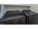 This laundry room features a new black Samsung washer and dryer, offering convenience and efficiency at 1004 Berwick Ct, Waxhaw, NC 28173