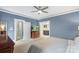 Spacious main bedroom with ensuite bathroom access and television; ceiling fan and neutral tones at 1004 Berwick Ct, Waxhaw, NC 28173