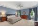Relaxing main bedroom features natural light from windows, neutral tones, and dresser storage at 1004 Berwick Ct, Waxhaw, NC 28173