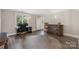 Bright home office with a large window, desk, bar, and modern flooring for a comfortable workspace at 1004 Berwick Ct, Waxhaw, NC 28173