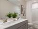 Well-lit bathroom features double sinks with modern fixtures and a shower with curtain at 12017 Grinstead Ln # 301, Charlotte, NC 28278
