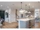 Open kitchen with stainless steel appliances, island, and pendant lighting at 12017 Grinstead Ln # 301, Charlotte, NC 28278