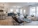 Bright living room features a large white sofa, modern decor, and open floorplan at 12017 Grinstead Ln # 301, Charlotte, NC 28278