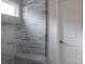 The tiled shower features a glass door and a built-in bench at 12017 Grinstead Ln # 301, Charlotte, NC 28278