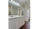 Bright bathroom featuring double vanity, quartz countertops, modern lighting, and wood-look floors at 12713 Frank Wiley Ln, Charlotte, NC 28278