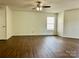 Open room featuring a ceiling fan, wood-look flooring, and natural light at 12713 Frank Wiley Ln, Charlotte, NC 28278