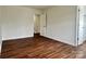 An inviting bedroom featuring hardwood floors and an entry to the upper stairs at 12713 Frank Wiley Ln, Charlotte, NC 28278