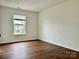 Inviting bedroom with hardwood floors and natural light from the window at 12713 Frank Wiley Ln, Charlotte, NC 28278