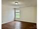 Bright bedroom with large window and hardwood floors at 12713 Frank Wiley Ln, Charlotte, NC 28278