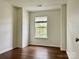 A bright, clean bedroom showcasing neutral walls and dark, attractive hardwood floors at 12713 Frank Wiley Ln, Charlotte, NC 28278