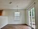 Inviting dining area with a sliding glass door to the deck and a chandelier at 12713 Frank Wiley Ln, Charlotte, NC 28278
