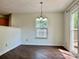 Bright dining room with stylish chandelier, wood floors and sliding glass door to deck at 12713 Frank Wiley Ln, Charlotte, NC 28278