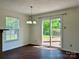 Bright dining room with stylish chandelier, wood floors and sliding glass door to deck at 12713 Frank Wiley Ln, Charlotte, NC 28278