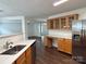 Spacious kitchen features stainless steel refrigerator, wood cabinets, and bright lighting at 12713 Frank Wiley Ln, Charlotte, NC 28278