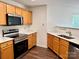 Kitchen featuring stainless steel appliances, wood cabinets and bright countertops at 12713 Frank Wiley Ln, Charlotte, NC 28278