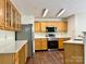 Spacious kitchen with stainless steel appliances and ample wood cabinets at 12713 Frank Wiley Ln, Charlotte, NC 28278