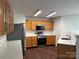 Modern kitchen with stainless steel appliances, white countertops, and wood cabinets at 12713 Frank Wiley Ln, Charlotte, NC 28278
