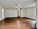 Spacious living room featuring hardwood floors and multiple windows for natural light at 12713 Frank Wiley Ln, Charlotte, NC 28278