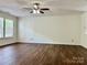 Spacious living room featuring ceiling fan, hardwood floors, and natural light at 12713 Frank Wiley Ln, Charlotte, NC 28278