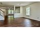 Bright living room featuring hardwood floors, neutral paint, and large windows at 12713 Frank Wiley Ln, Charlotte, NC 28278