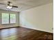 Spacious living room featuring ceiling fan, hardwood floors, and natural light at 12713 Frank Wiley Ln, Charlotte, NC 28278