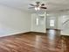 Spacious living area with wood-look flooring and multiple windows for plenty of natural light throughout at 12713 Frank Wiley Ln, Charlotte, NC 28278