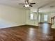 Bright living room featuring ceiling fan, hardwood floors, and neutral paint at 12713 Frank Wiley Ln, Charlotte, NC 28278