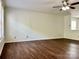Spacious living room featuring ceiling fan, hardwood floors, and natural light at 12713 Frank Wiley Ln, Charlotte, NC 28278